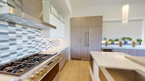 Gourmet kitchen with 6 burner gas stove, built in refrigerator and win chiller