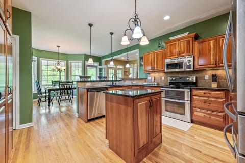 Open-concept kitchen with a central island, modern appliances, and ample natural light