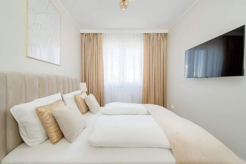 Soft bedding, light curtains and subtle lighting create a relaxing atmosphere perfect for a restful night's sleep.

