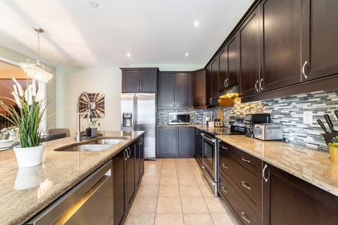Featuring sleek stainless steel appliances, ample storage with easy-to-reach cabinets, and a spacious layout perfect for preparing meals together.  It offers all the space and tools you need to make mealtime a fun and effortless part of your day!