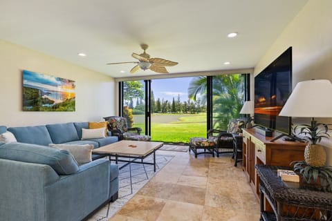 Bright living area framed by wide windows opening to swaying palms & fresh island breezes.