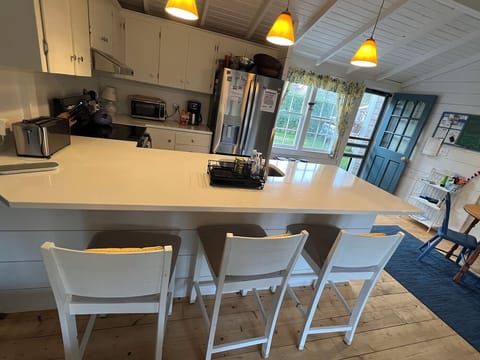 new kitchen with 3 barstool seating
