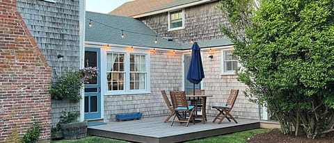 new deck off kitchen with outdoor table and umbrella , seats 4-5