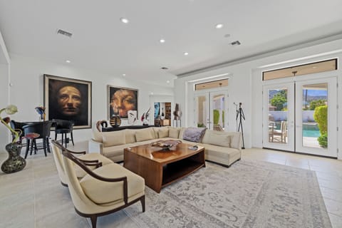 Living Room with french doors out to the pool area and fairway.