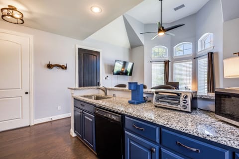 Cabinets stocked with flatware, cooking utensils, pots/pans, cleaning supplies.