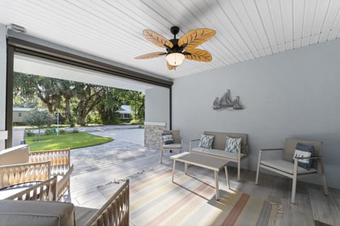 Enjoy a breezy and shaded outdoor lounge area with plenty of comfortable seating, perfect for relaxing after a day at the beach.