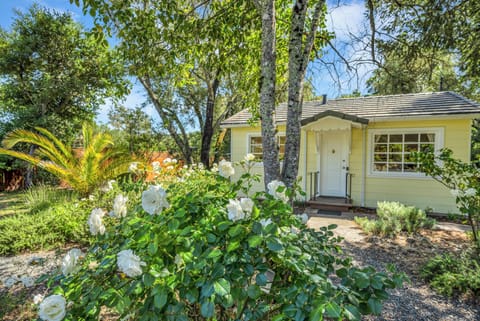 Charming exterior surrounded by vibrant flowers.
