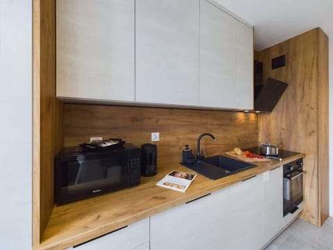 The kitchen's contemporary decor complements the apartment's style.