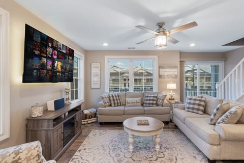 Cozy and inviting living room with plush seating, Roku Smart TV. 