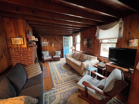 Cozy wood-paneled living room with two pull out sofa beds