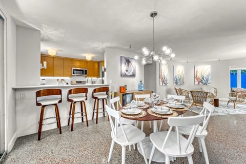 An area made for gathering: prep space, bar seating, and laughter at the center of it all.