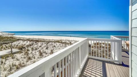 Stunning beachfront deck overlooking pristine white sand and turquoise waters, perfect for morning coffee or evening relaxation.