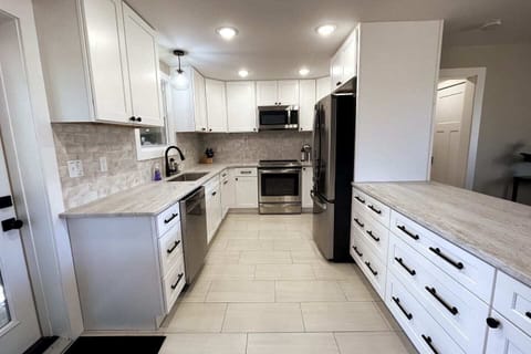 Kitchen is stocked with pots, pans, baking sheets, toaster, blender, baking pans, and more.