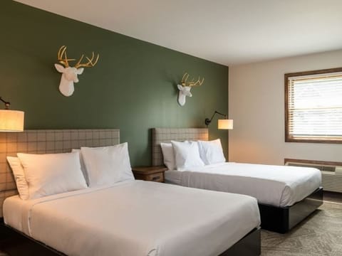 Stretch out on fresh linens beneath charming cabin-inspired decor.