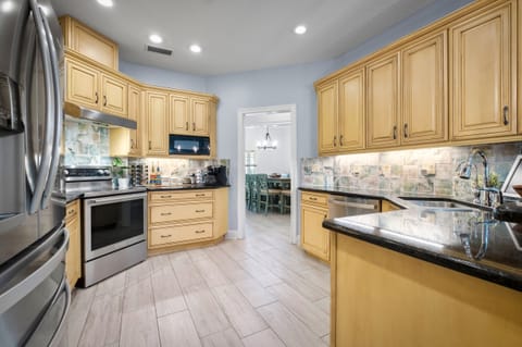 Kitchen is fully stocked for most cooking needs.