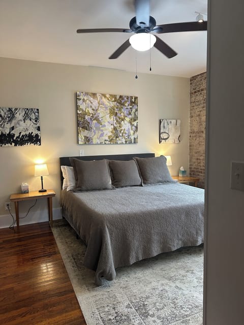 View of King-sized bed with art. The bed is so comfy folks ask how to buy it. 