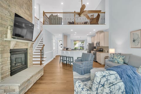 1st floor den with electronic ignition gas fireplace, kitchen, and loft