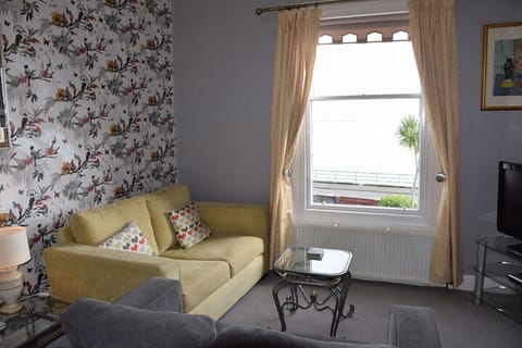 Living area with sea  and garden views