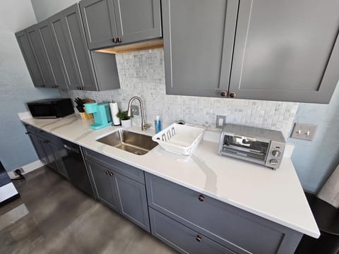 Kitchen counters, sink, and countertop appliances.