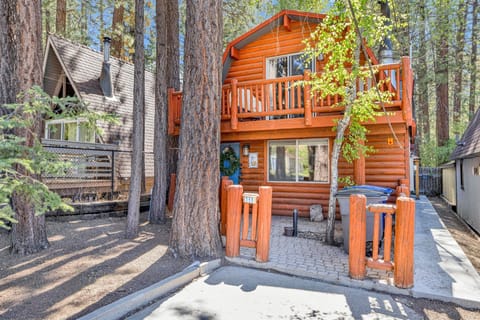 Welcoming cabin entry surrounded by towering pine trees, offering fresh mountain air and a peaceful forest setting—the perfect first impression for your Big Bear Lake getaway.