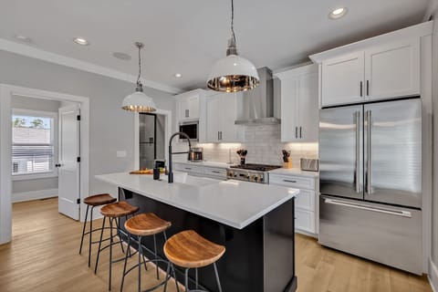 2nd Floor: Fully equipped kitchen, complete with all essential culinary tools, boasts stainless-steel appliances and a spacious island with ample counter space and bar seating.