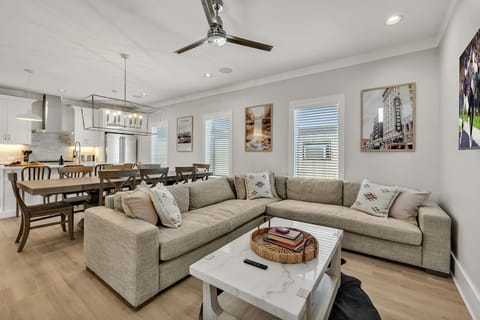 2nd Floor: Warm and inviting open-concept living space seamlessly flowing the designer furnished living room with the fully equipped kitchen and dining area.