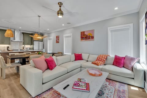 2nd Floor: Warm and inviting open-concept living space seamlessly flowing the designer furnished living room with the fully equipped kitchen and dining area.