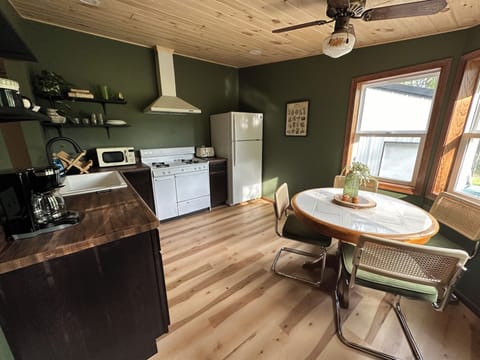 Kitchen equipped with dishes, toaster, oven/stove, microwave, and coffee!