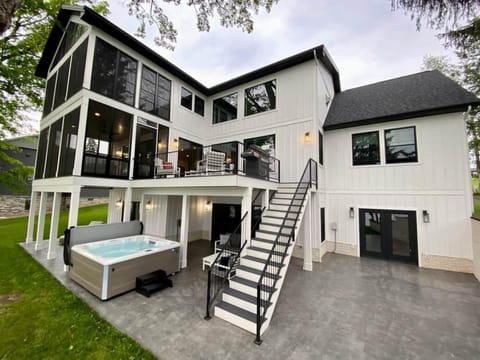 Multiple outdoor living spaces, hot tub, and oversized gas grill