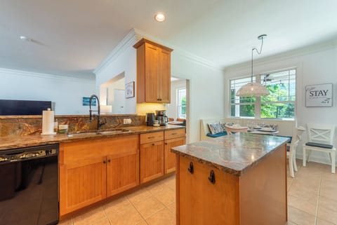 Kitchen with dishwasher, drip-style coffee pot, electric kettle, and breakfast nook