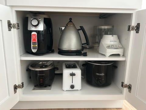- Fully equipped with multiple kitchen appliances for cooking  
- Toaster, blender, kettle, air fryer, crock pot and rice cooker provided  
- Convenient setup for preparing meals with ease  
