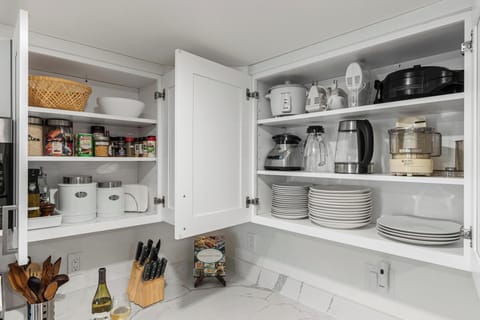 - Kitchen cabinets stocked with cookware dishes and essentials  
- Appliances including coffee maker blender and toaster  
- Ready for extended stays with everything needed to cook  
