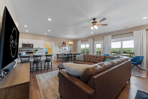 Upstairs living room holds a 75" TV with a Nintendo Switch.