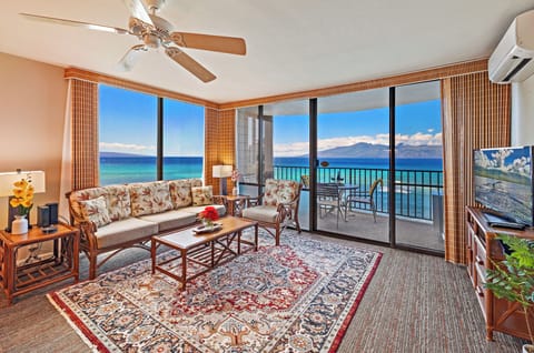 Condo living room featuring panoramic view of famous sandy Kahana beach, Maui!