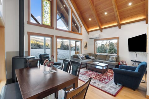 Bright open living space with vaulted ceilings and mountain views