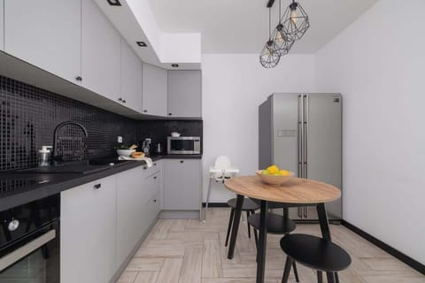 A view of the kitchen island and round dining table. The space is both functional and visually appealing.