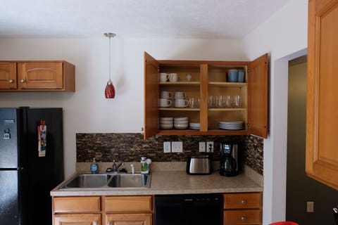 Full kitchen with coffee maker, toaster, microwave, dishwasher and setting for 8