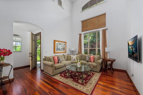 Spacious living room with vaulted ceilings and tall windows