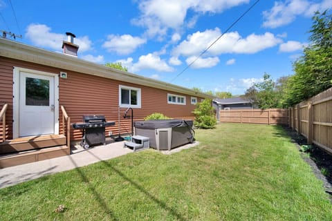 Backyard featuring a hot tub and grill!