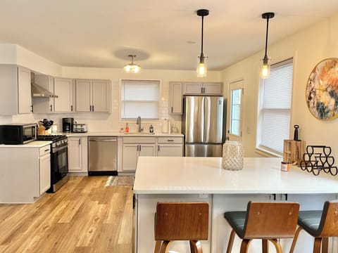 Quartz countertops. Bar seats 3 people.