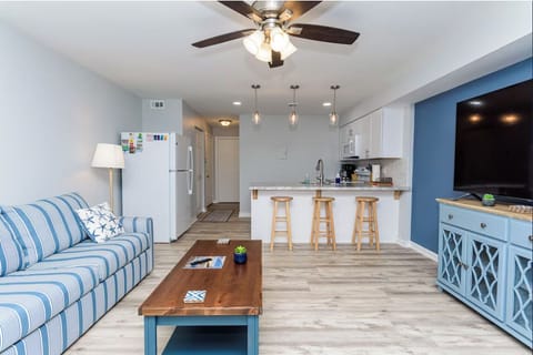 Living room with view into kitchen