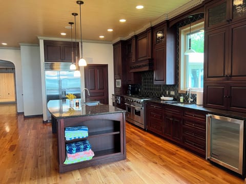 Large kitchen with wine fridge and all the amenities to stay in and cook at home