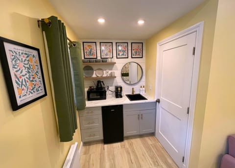 Adorable kitchenette with tasteful dinnerware perfect for light meals.  