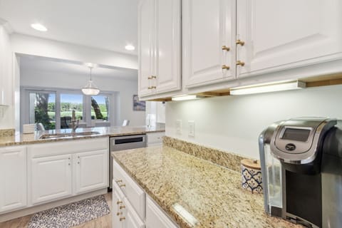 Meal Preparation is a Breeze in the Updated Kitchen with Pristine White Cabinetry, Granite Countertops and Stainless Steel Appliances