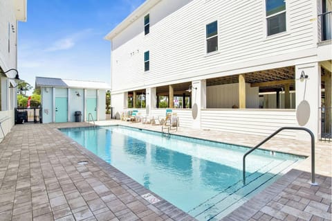 A sun-drenched oasis surrounded by modern amenities, inviting you to a refreshing retreat.