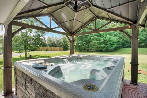 Whether day or night, soak in serenity under the stars or sunshine in this inviting hot tub escape—pure bliss awaits.