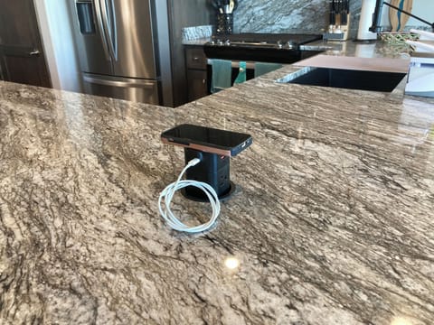 Pop-up phone charger. Can handle several. Merely push down when not in use.