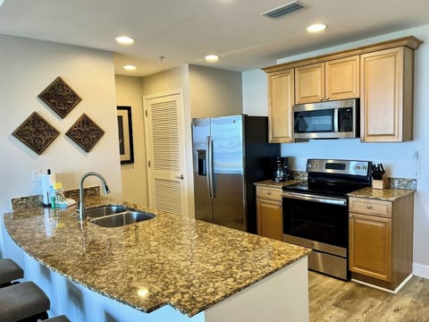 The fully equipped kitchen features granite countertops, stainless appliances and has everything you need to prepare meals for family & friends.