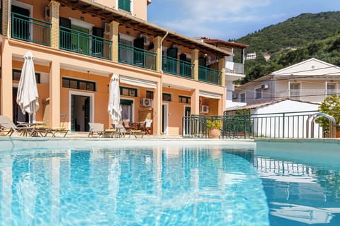 "Villas Delphine and Nikos By Tsiolis Family next to each other. Relax by the large shared swimming pool with sunbeds and umbrellas, perfect for unwinding under the Corfiot sun."