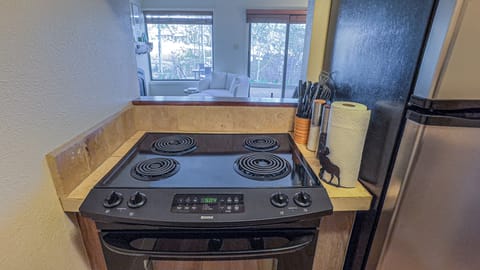 [Kitchen] Galley kitchen includes oven, fridge, dishwasher, microwave, pots/pans